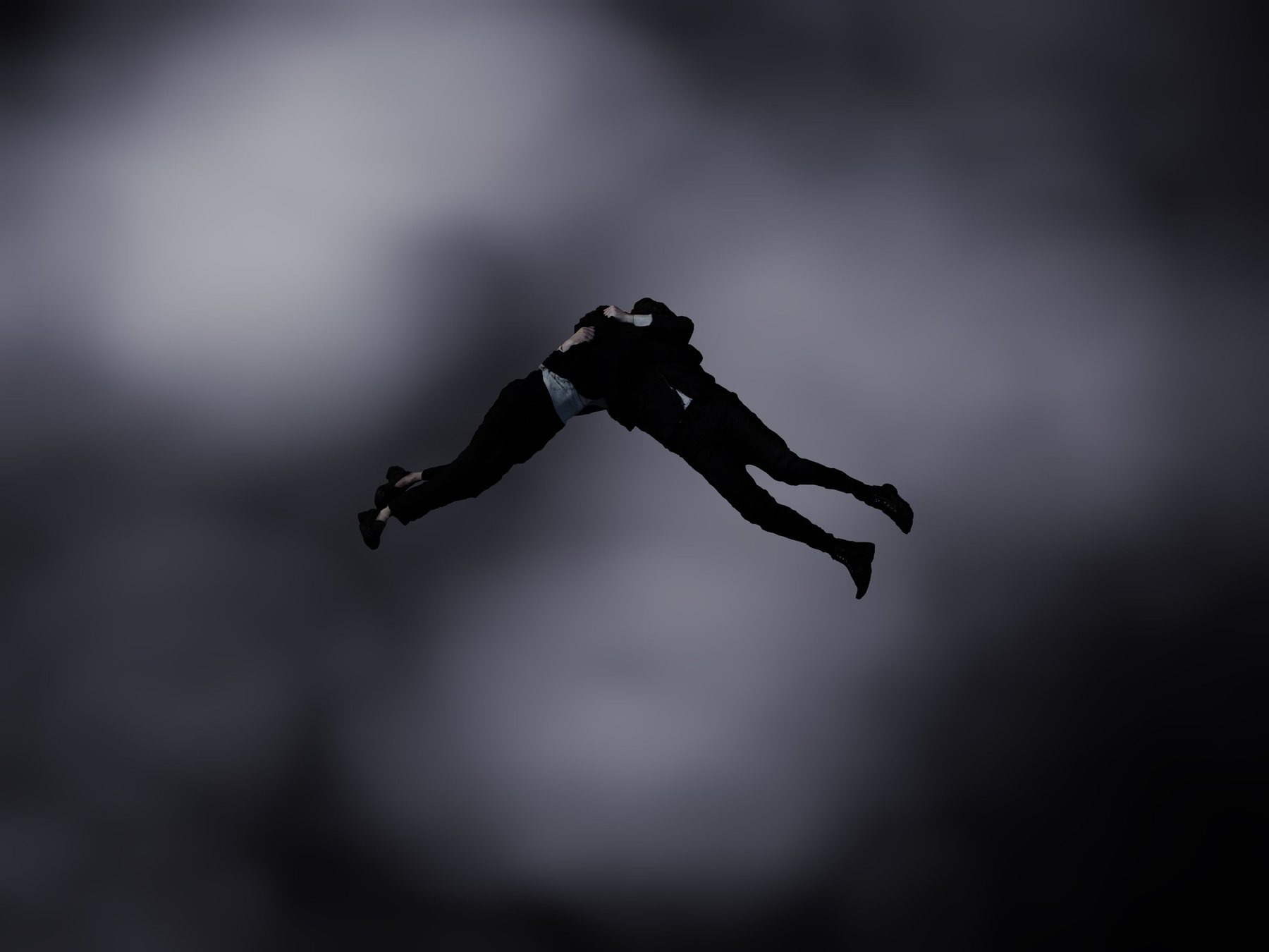 Two dark-suited figures locked in an embrace, falling through a cloudy grey sky; Encounter scene study in silhouette.