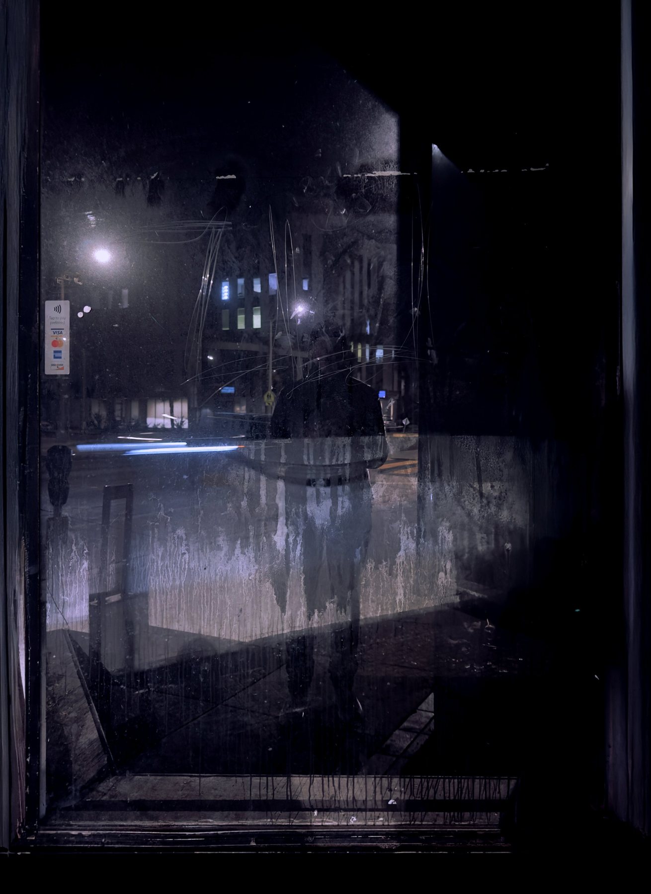 No End In Sight 111: A grimy night window streaked with white residue, reflecting street lights, a blurred car and the artist as a pale ghostly figure.