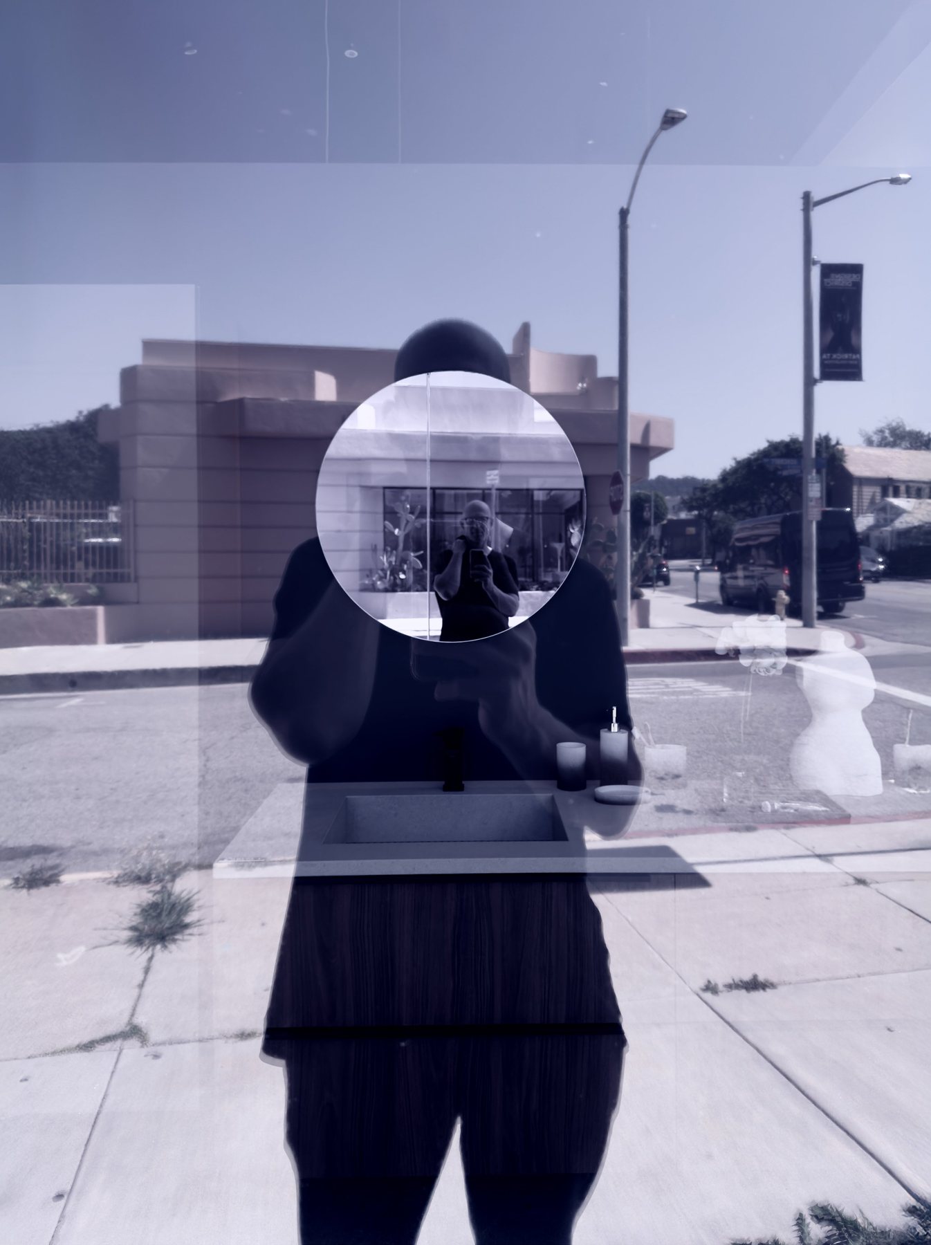 No End In Sight 147: The artist's reflection with a bright circular cut-out showing a second, smaller reflection, over a sunlit street in cool blue tones.