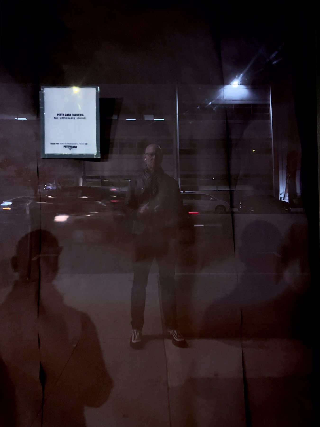 No End In Sight 153: The artist's reflection in a dark night window with a lit notice at left, flanked by two ghostly shadow figures.