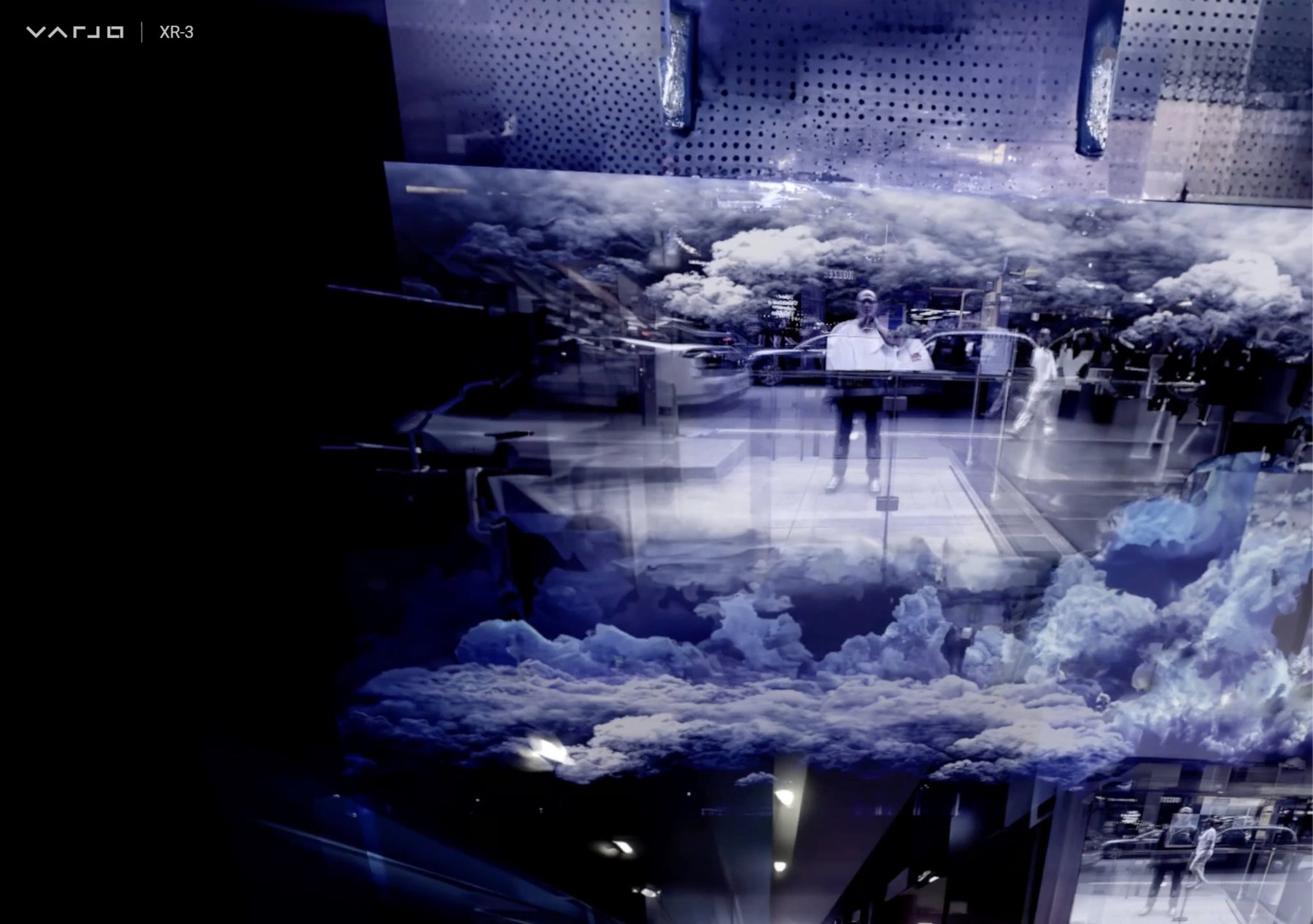 Varjo XR-3 view of luminous blue clouds layered through a glass-walled space, with a person reflected inside.